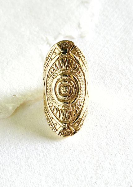Gold badge with intricate design on a white background