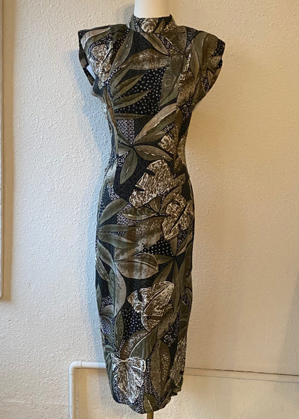 Patterned dress on a mannequin against a plain wall