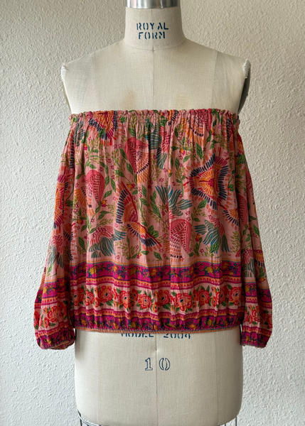 Floral patterned top on a mannequin against a plain background