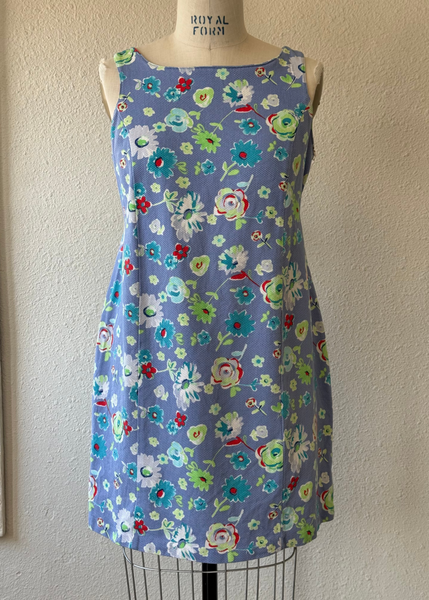 Floral dress on a mannequin against a plain wall