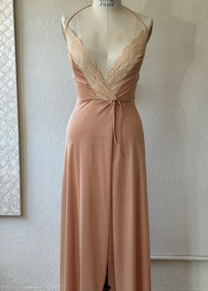 Long beige dress on a mannequin against a plain wall