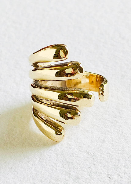 Gold spiral ring on a white background