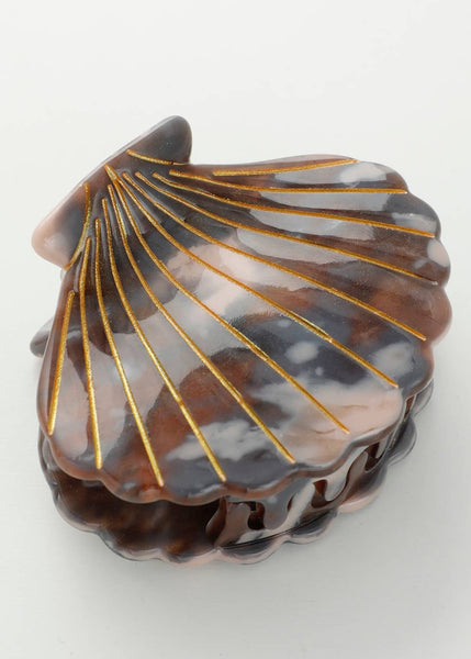 Shell-shaped hair clip with gold accents on a white background